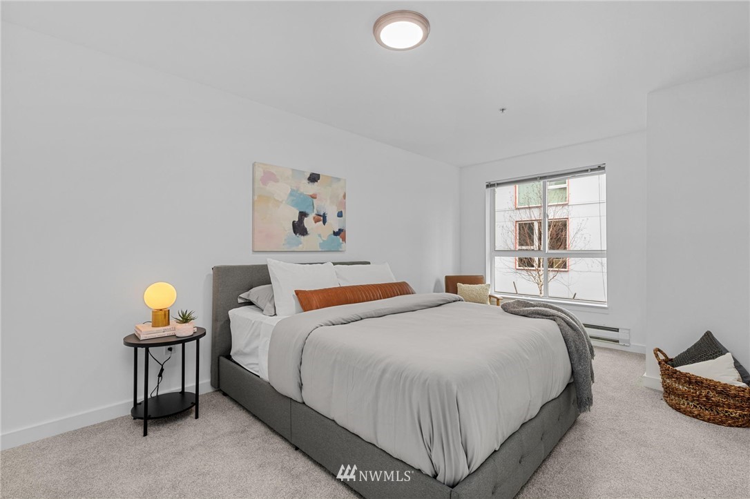 108 5th Avenue South, Unit 710 Seattle, WA 98104 - Photo 8 of 22 a bedroom with bed and a window
