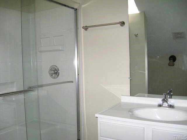 611 Brent Road Raleigh, NC 27606 - Photo 8 of 10 a bathroom with a sink and mirror