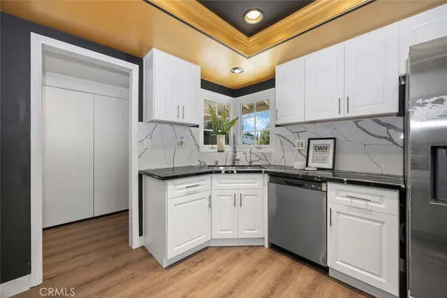 a kitchen with stainless steel appliances granite countertop a sink and cabinets