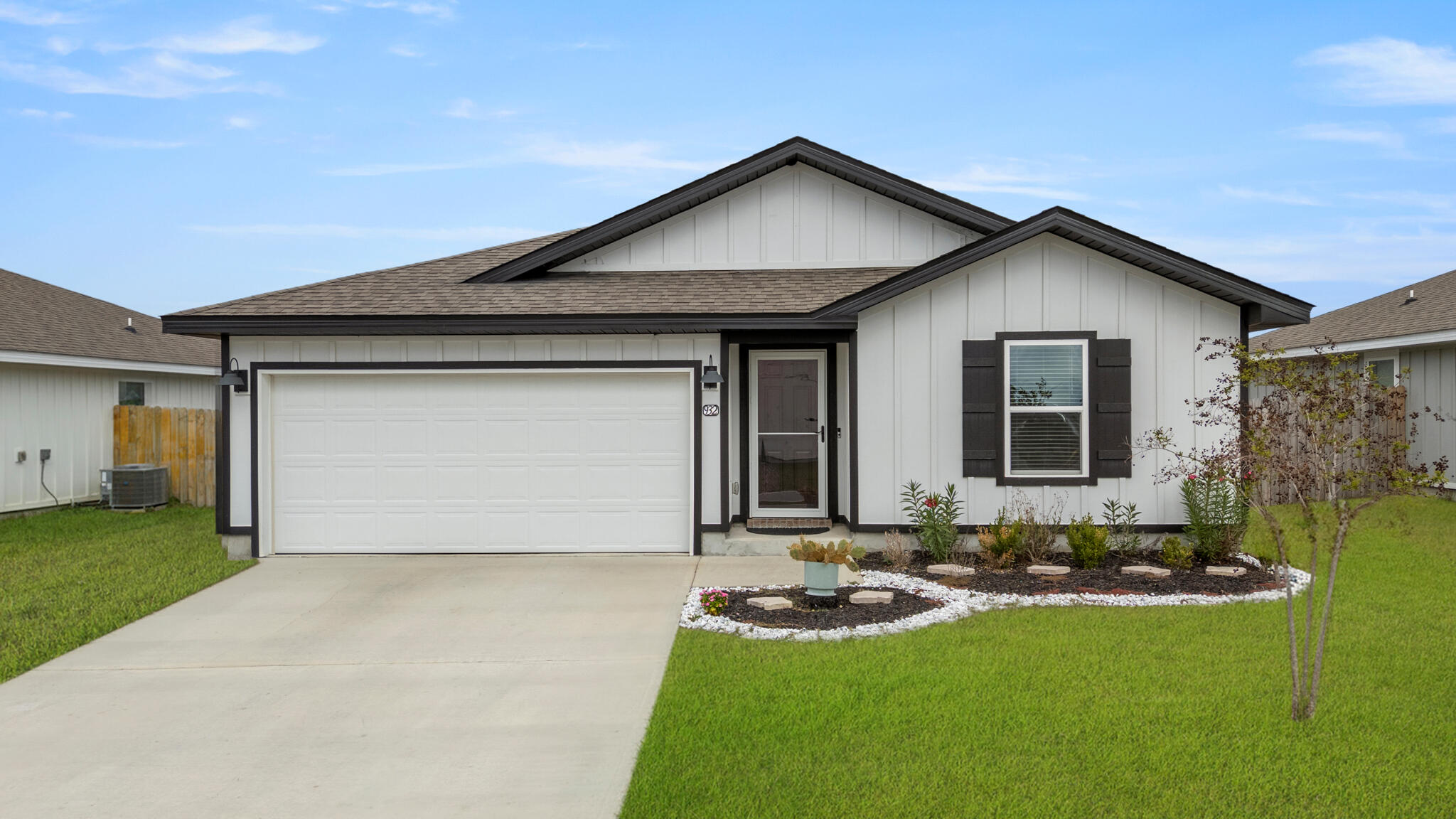a front view of house with yard and garage