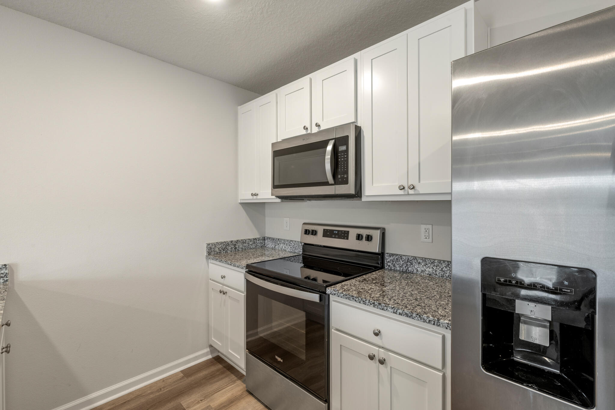 932 Sandbar Loop Crestview, FL 32539 - Photo 12 of 44 a kitchen with a stove and a microwave