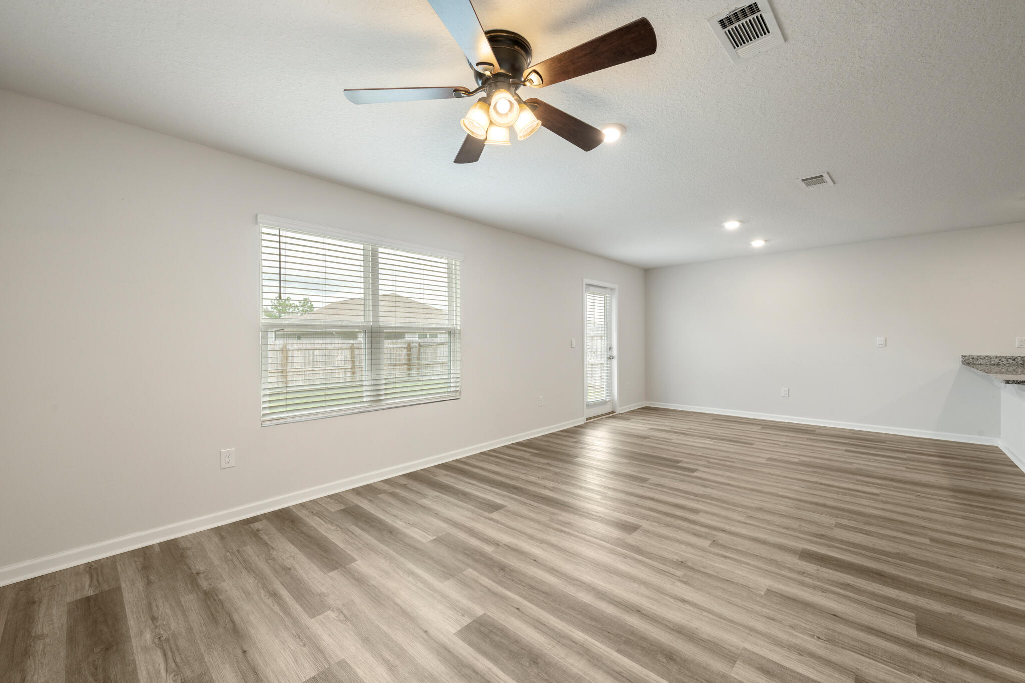 932 Sandbar Loop Crestview, FL 32539 - Photo 15 of 44 wooden floor in an empty room with a window