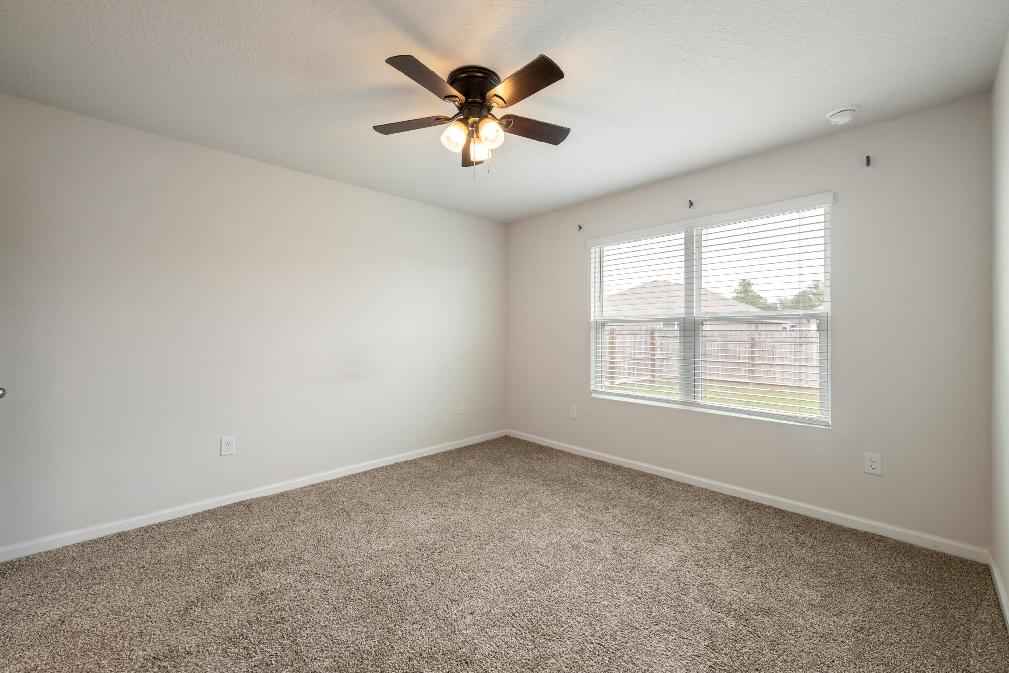 932 Sandbar Loop Crestview, FL 32539 - Photo 19 of 44 an empty room with ceiling fan and window