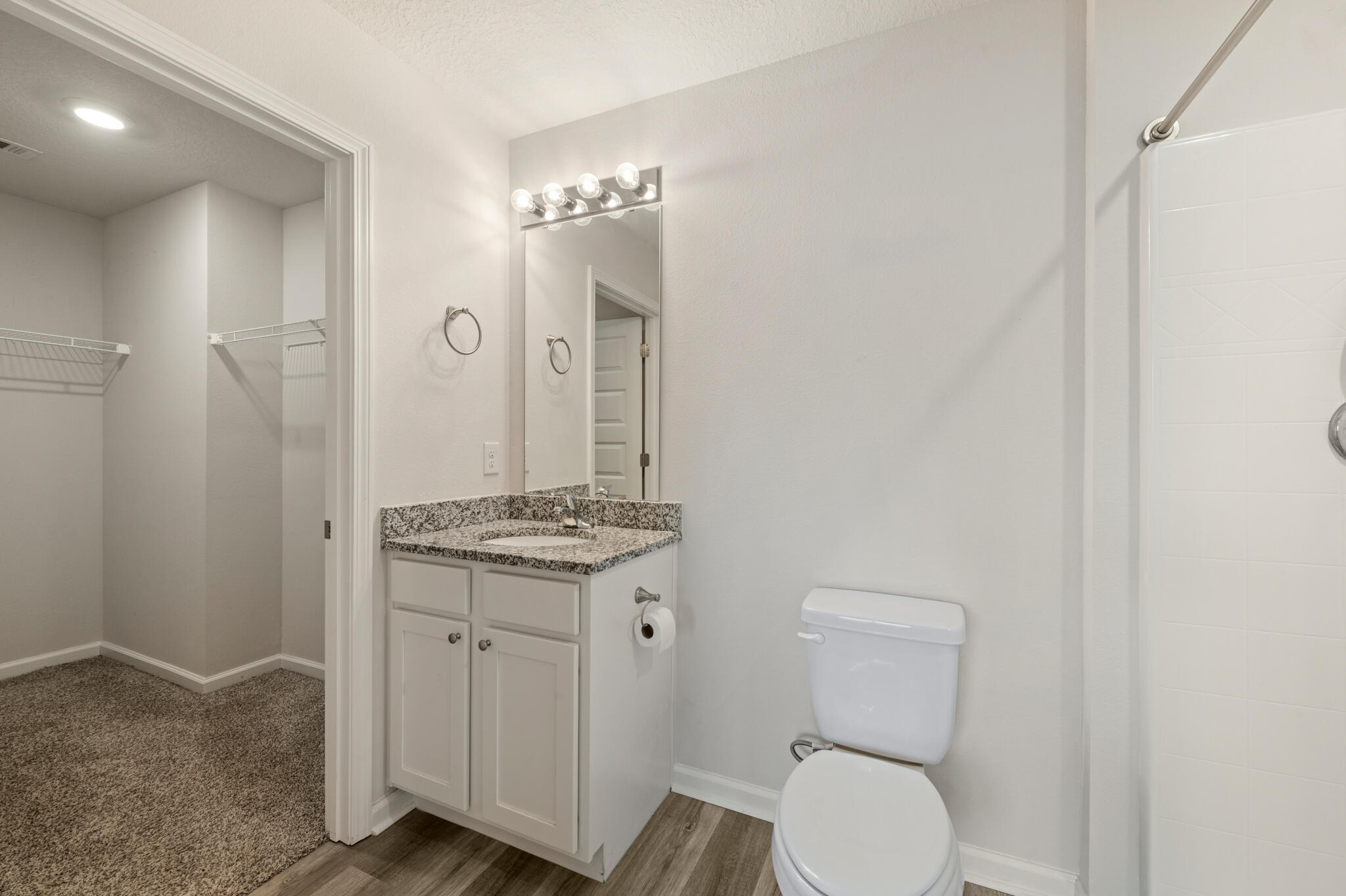 932 Sandbar Loop Crestview, FL 32539 - Photo 23 of 44 a bathroom with a granite countertop toilet a sink and a mirror