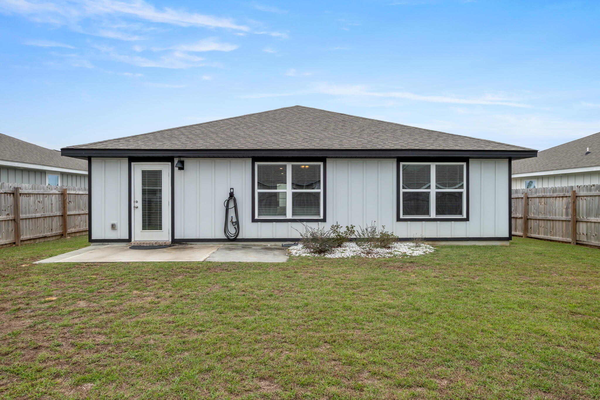 932 Sandbar Loop Crestview, FL 32539 - Photo 33 of 44 a front view of a house with a garden and yard