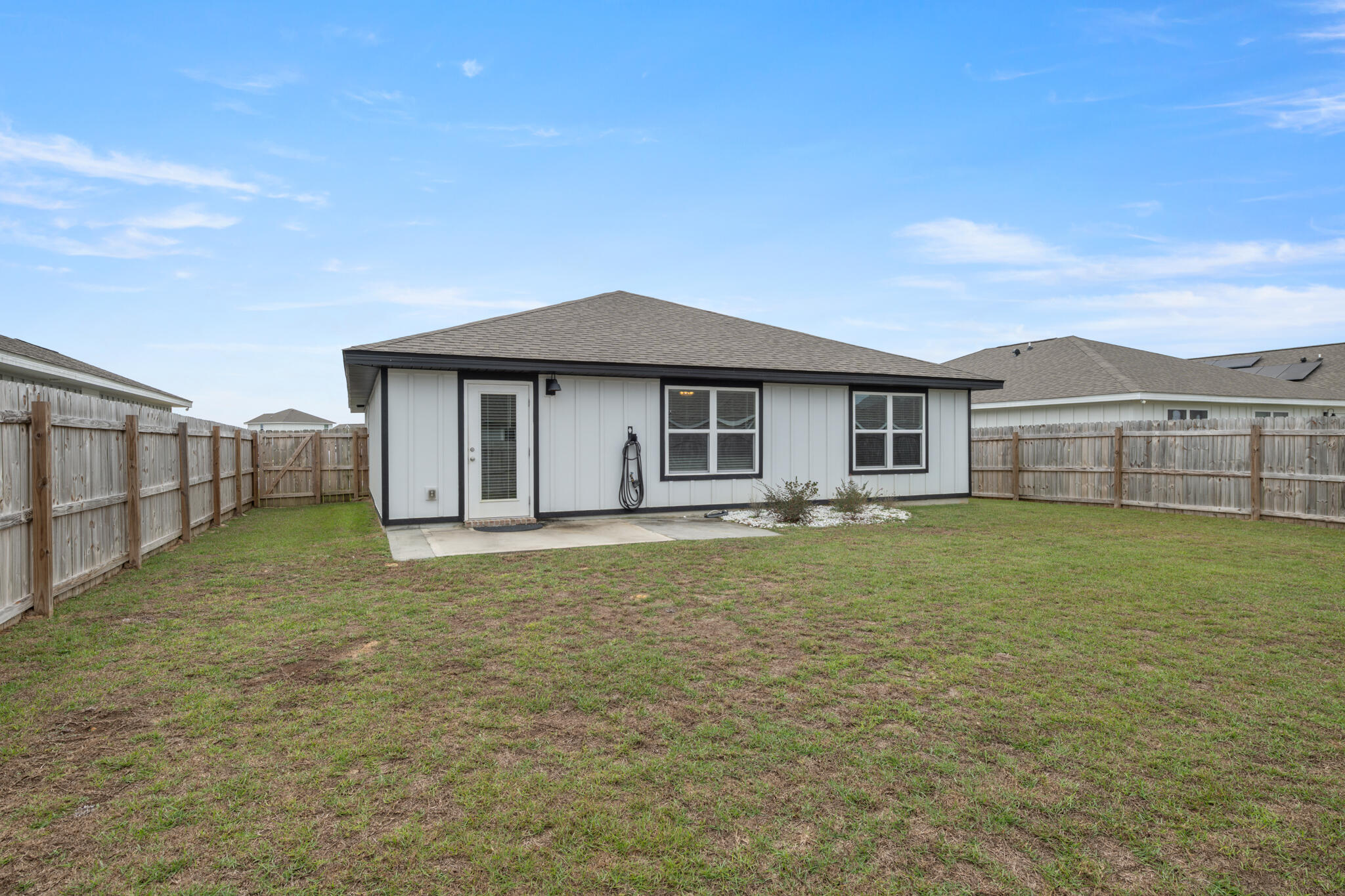 932 Sandbar Loop Crestview, FL 32539 - Photo 35 of 44 a front view of a house with a garden and yard