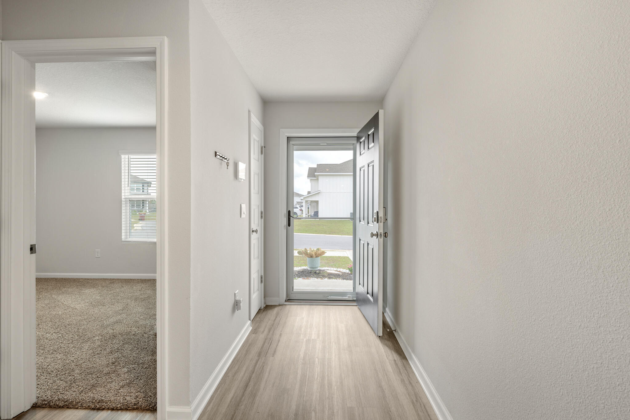 932 Sandbar Loop Crestview, FL 32539 - Photo 5 of 44 a view of a hallway with wooden floor