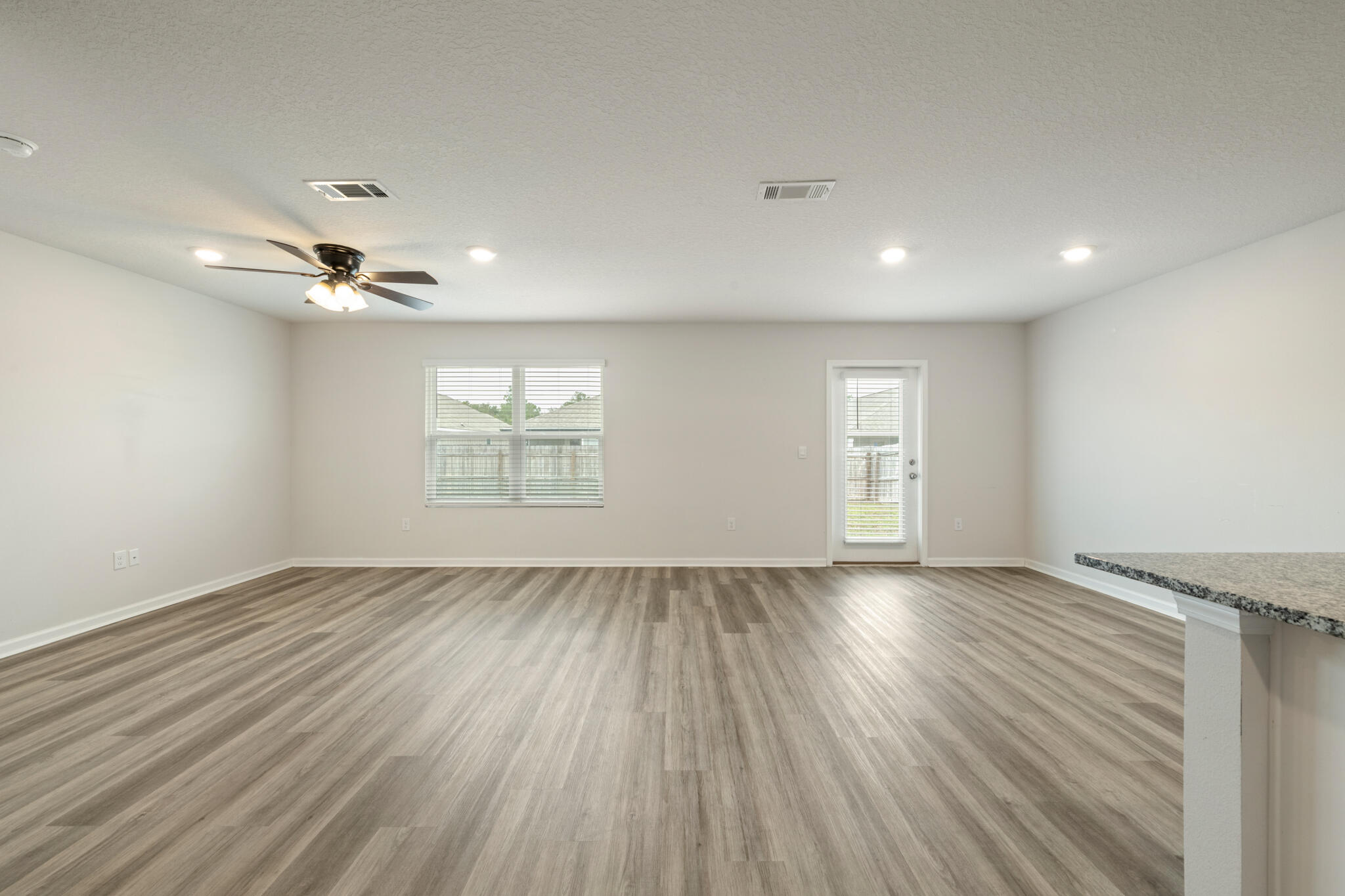 932 Sandbar Loop Crestview, FL 32539 - Photo 9 of 44 wooden floor in an empty room with a window