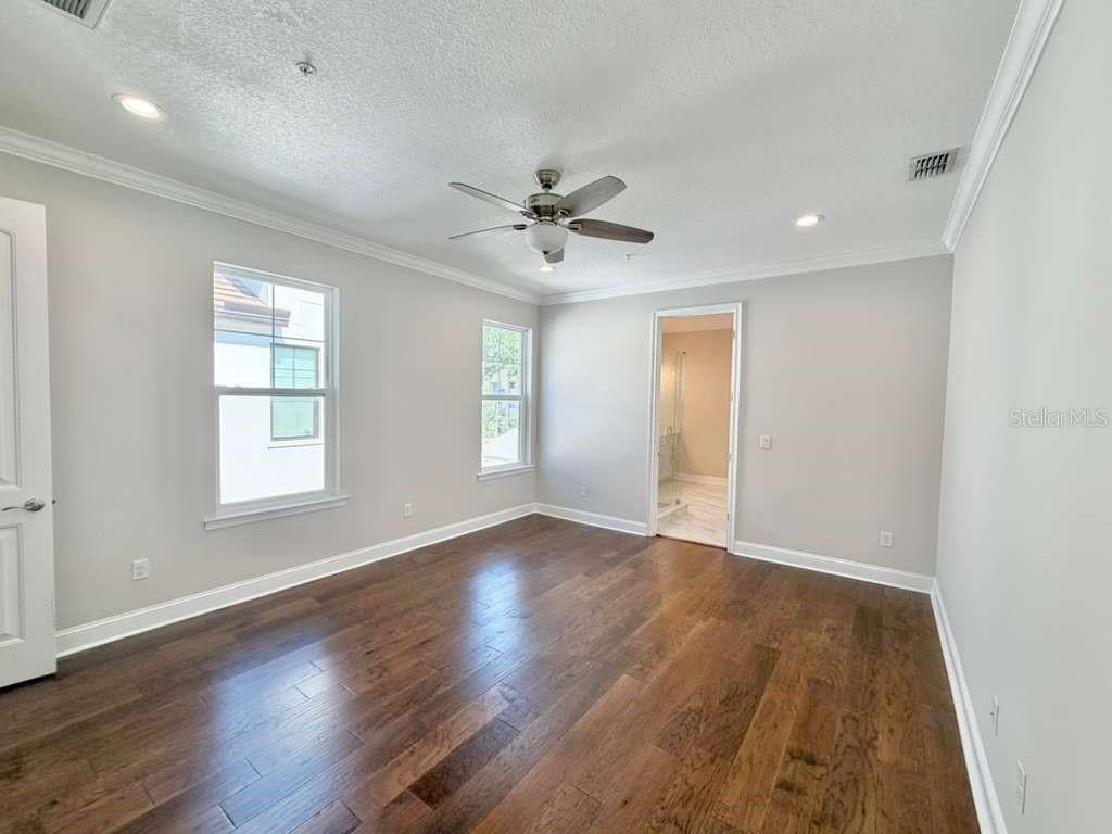 4606 West Fig Street, Unit 2 Tampa, FL 33609 - Photo 13 of 26 a view of an empty room with window and wooden floor