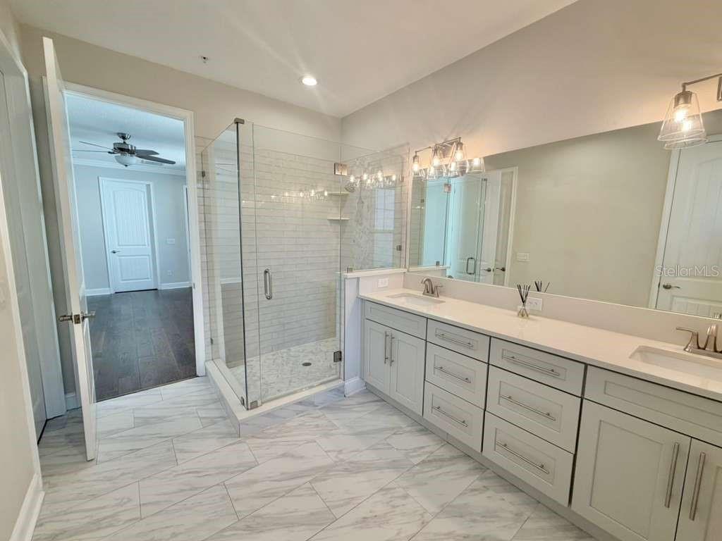 4606 West Fig Street, Unit 2 Tampa, FL 33609 - Photo 16 of 26 a bathroom with a double vanity sink mirror and shower