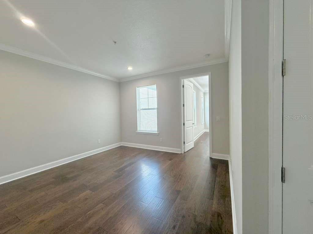 4606 West Fig Street, Unit 2 Tampa, FL 33609 - Photo 18 of 26 a view of an empty room with wooden floor and a window