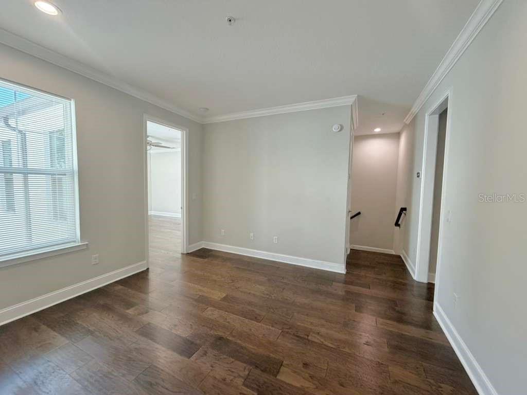 4606 West Fig Street, Unit 2 Tampa, FL 33609 - Photo 19 of 26 a view of an empty room with wooden floor and a window
