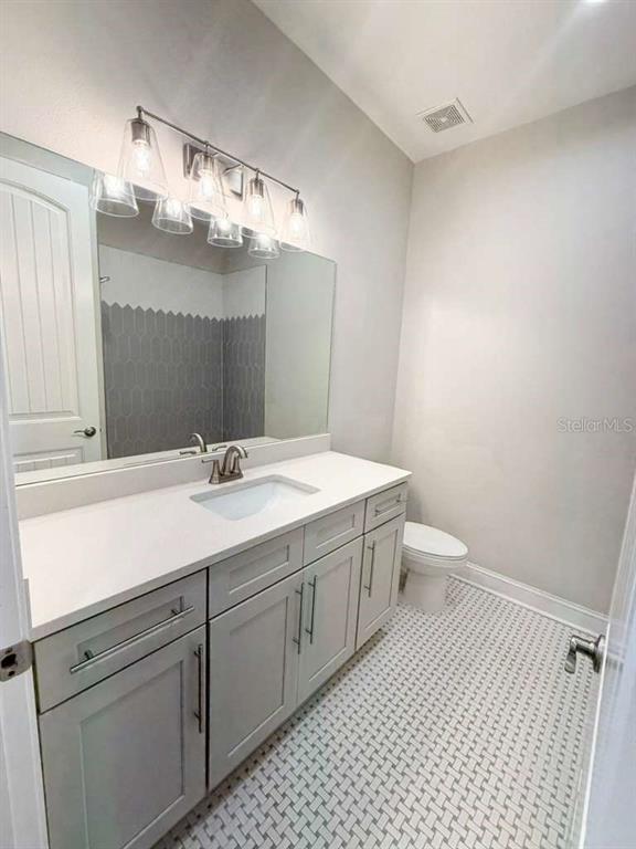 4606 West Fig Street, Unit 2 Tampa, FL 33609 - Photo 21 of 26 a bathroom with a sink a toilet and mirror