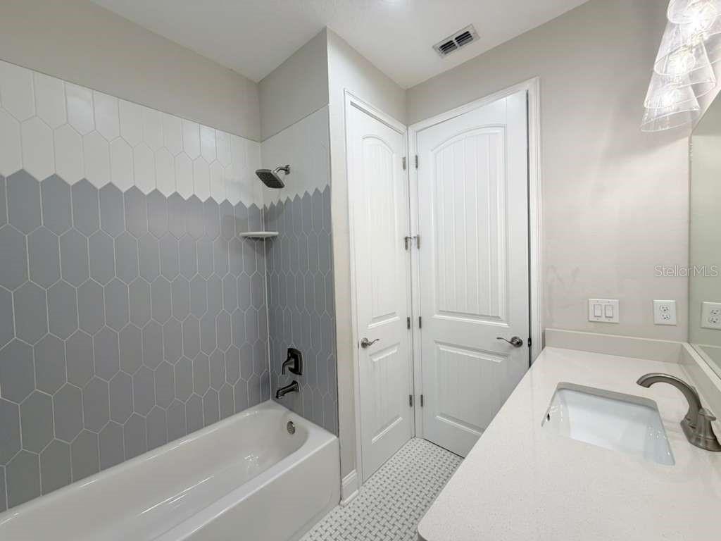 4606 West Fig Street, Unit 2 Tampa, FL 33609 - Photo 22 of 26 a bathroom with a tub shower vanity and a sink