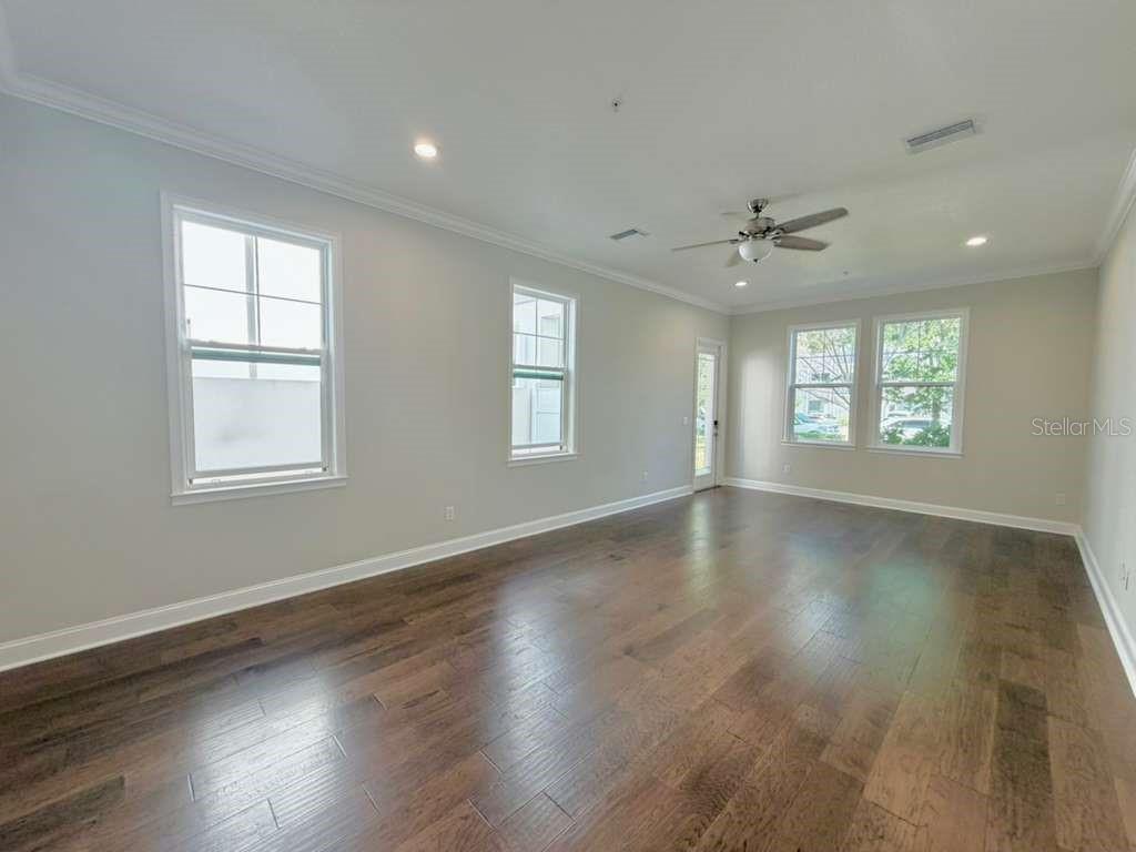 4606 West Fig Street, Unit 2 Tampa, FL 33609 - Photo 4 of 26 a view of an empty room with wooden floor and a window