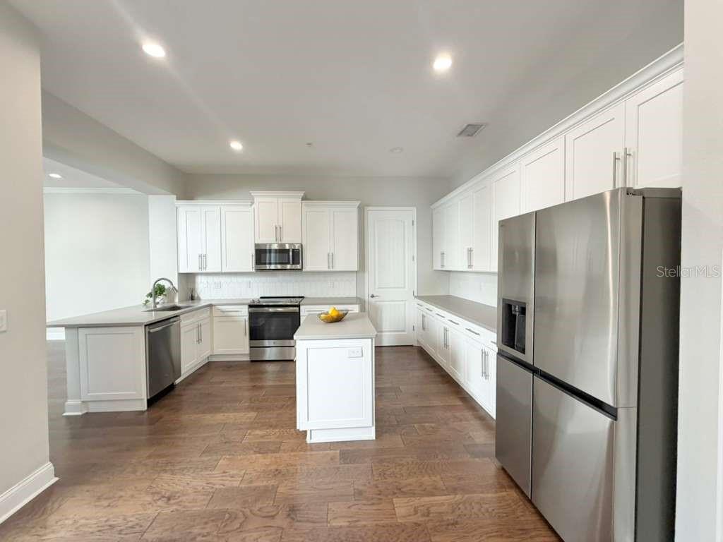 4606 West Fig Street, Unit 2 Tampa, FL 33609 - Photo 7 of 26 a large kitchen with a large counter top appliances and cabinets