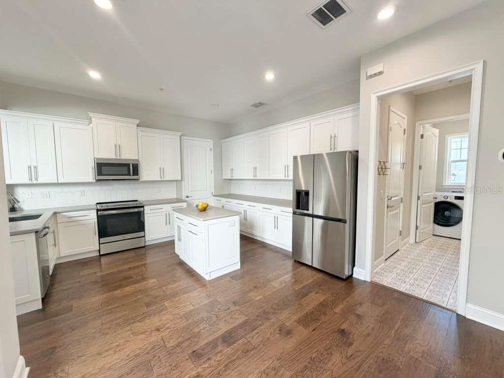 4606 West Fig Street, Unit 2 Tampa, FL 33609 - Photo 10 of 26 a kitchen with stainless steel appliances a refrigerator and a stove top oven