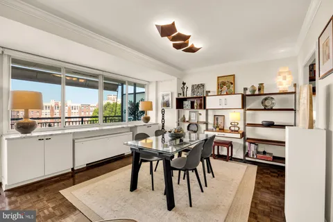 a kitchen with kitchen island a dining table and chairs