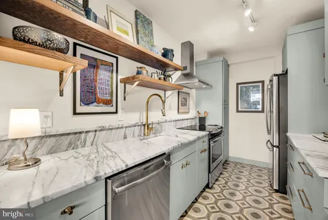 a bathroom with a granite countertop sink a mirror and vanity