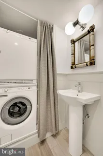 a utility room with sink dryer and washer