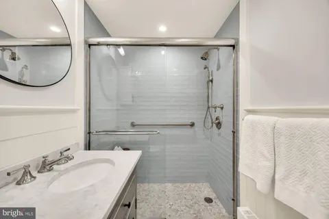 a bathroom with a sink double vanity and a mirror