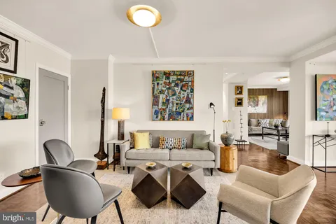 a living room with furniture a rug and a chandelier