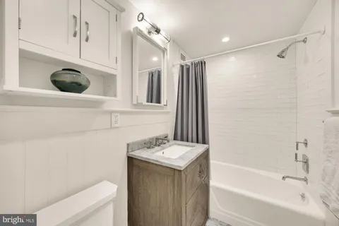 a bathroom with a sink a toilet and a bathtub