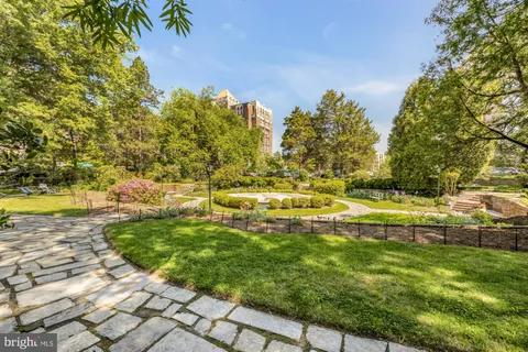 a view of yard with swimming pool and green space