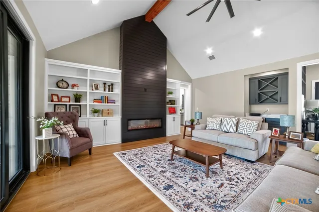 a living room with furniture and wooden floor