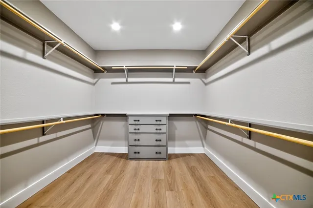 a view of room with window and wooden floor