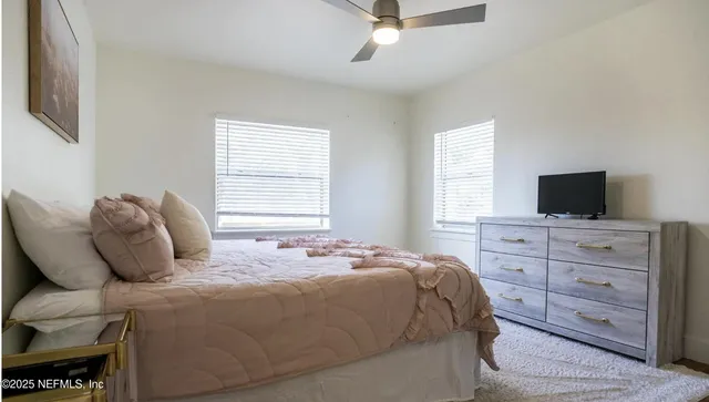 a bedroom with a bed and flat screen tv