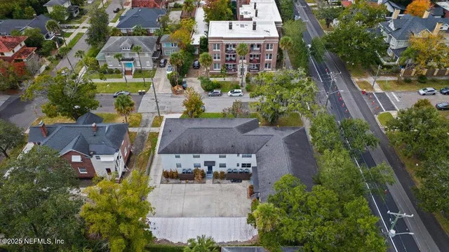 an aerial view of multiple houses with yard
