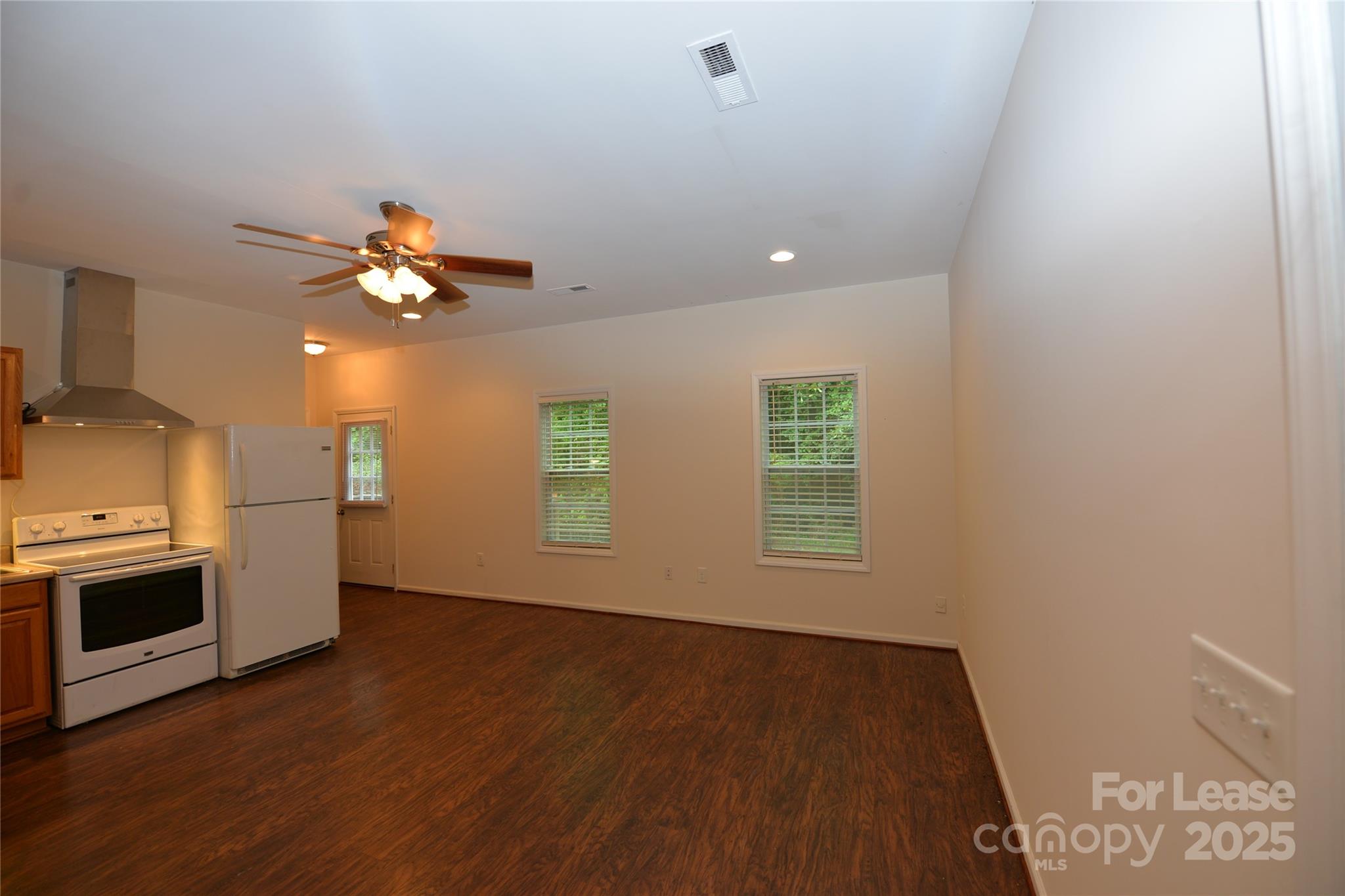 735 Seven Springs Way Denver, NC 28037 - Photo 8 of 11 a view of an empty room with a kitchen and a window