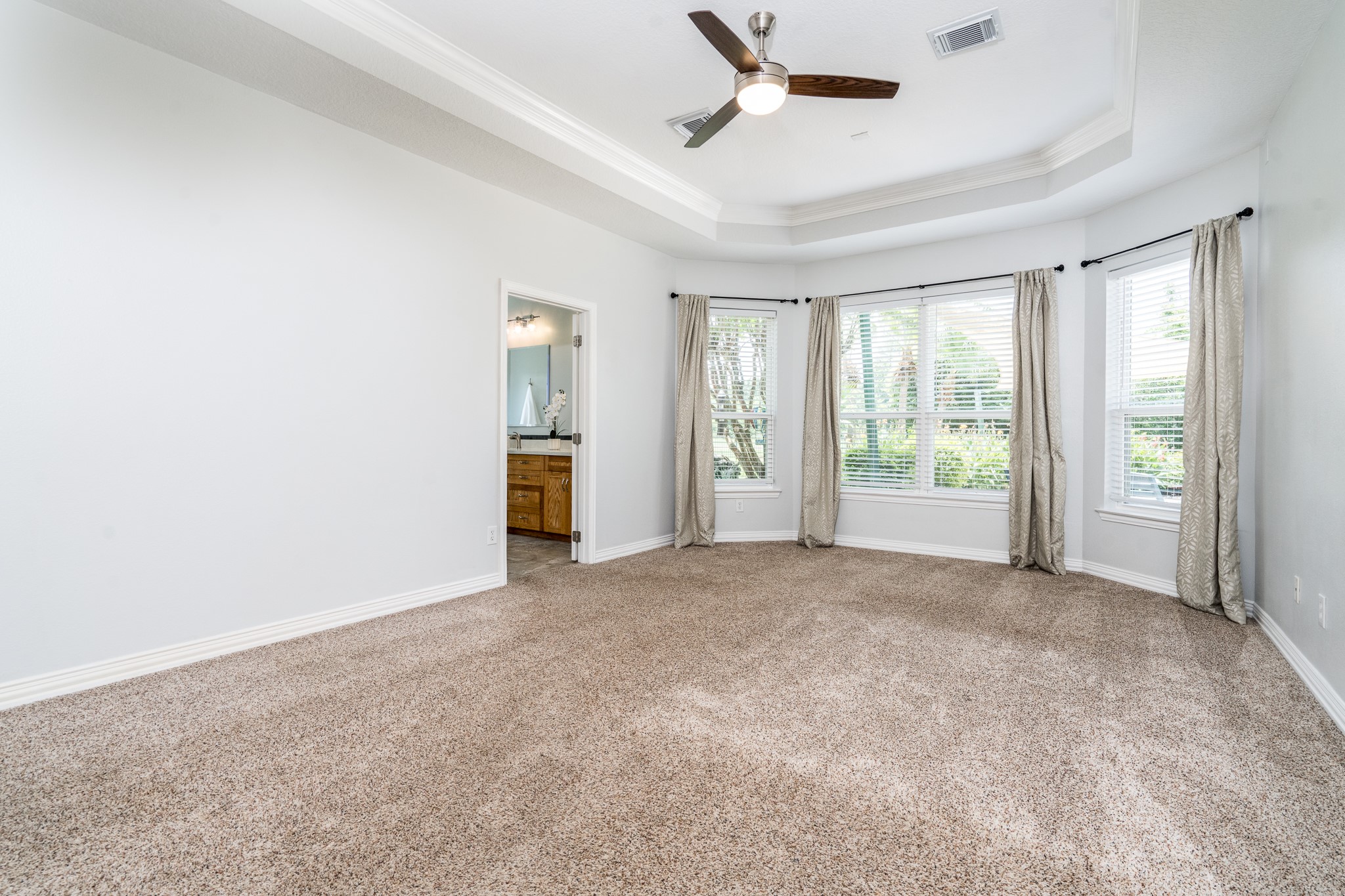 5914 Oakmoss Trail Spring, TX 77379 - Photo 15 of 50 The first floor primary suite offers sweeping views of the pool and golf course beyond.