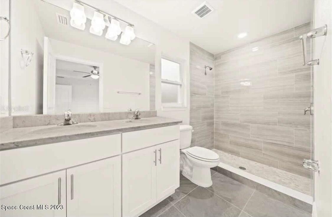 2351 Angel Road Palm Bay, FL 32909 - Photo 8 of 16 a bathroom with a double vanity sink toilet and shower