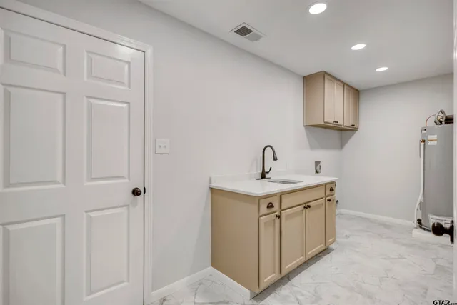 a view of a storage & utility room with a sink