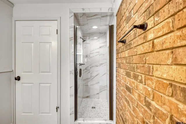 a bathroom with a glass shower door