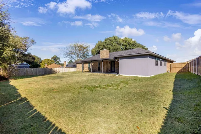 a house view with swimming pool in front of it