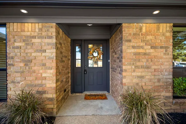 a view of entrance with a door and wooden floor