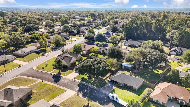 an aerial view of residential house with outdoor space and swimming pool