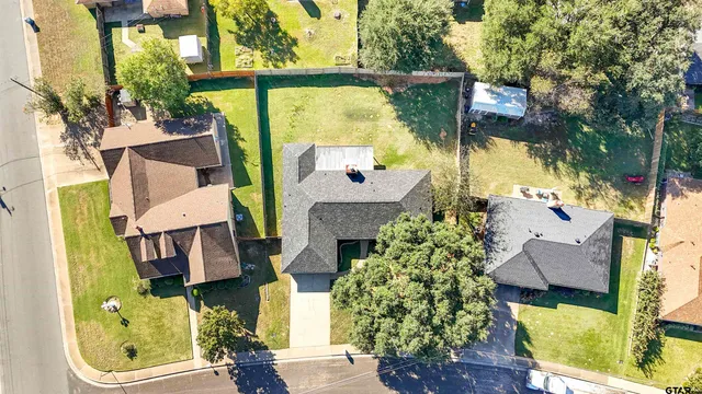 aerial view of a house with a yard and balcony