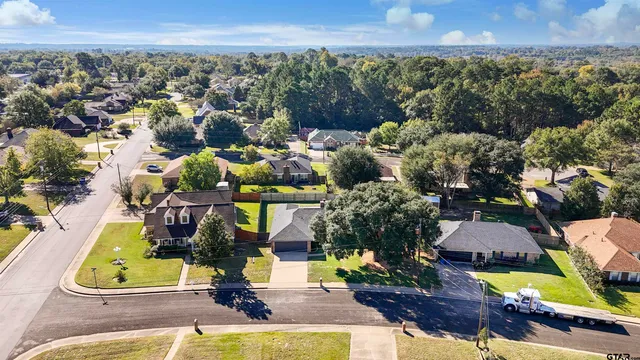 an aerial view of residential houses with outdoor space and swimming pool