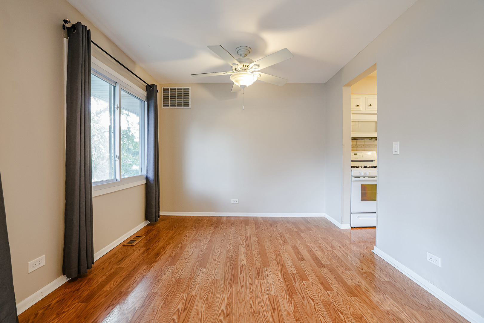 3008 Roberts Drive, Unit 5 Woodridge, IL 60517 - Photo 16 of 22 a view of empty room with wooden floor and fan