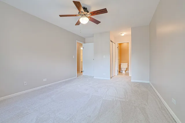 an empty room with fan and a ceiling fan