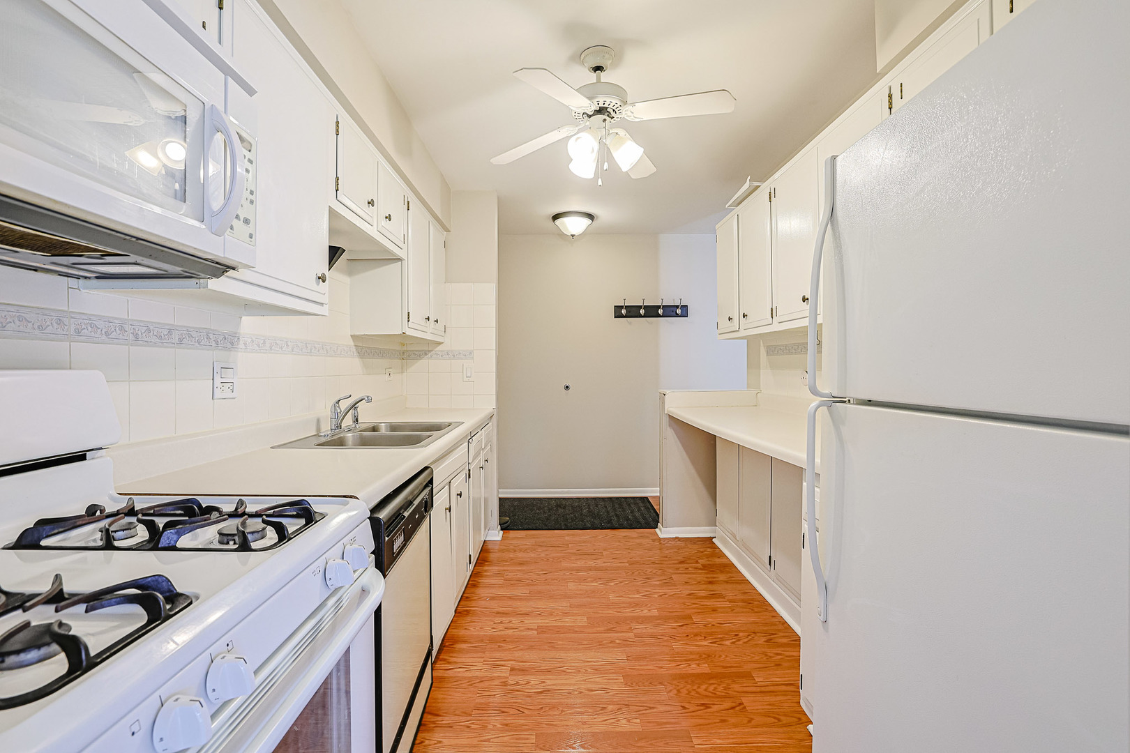 3008 Roberts Drive, Unit 5 Woodridge, IL 60517 - Photo 21 of 22 a kitchen with sink a stove and a refrigerator