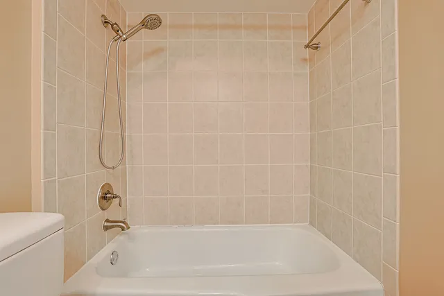 a bathroom with a shower and a bath tub