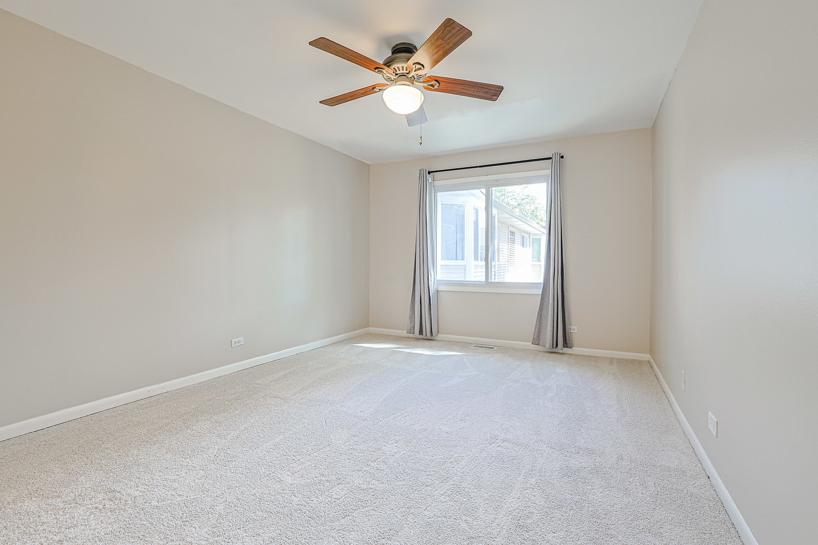 3008 Roberts Drive, Unit 5 Woodridge, IL 60517 - Photo 6 of 22 an empty room with windows and ceiling fan