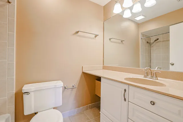a bathroom with a sink mirror vanity and toilet