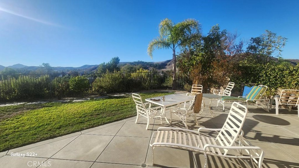 4591 Camino Del Sol Calabasas, CA 91302 - Photo 14 of 21 a view of a patio with table and chairs and potted plants