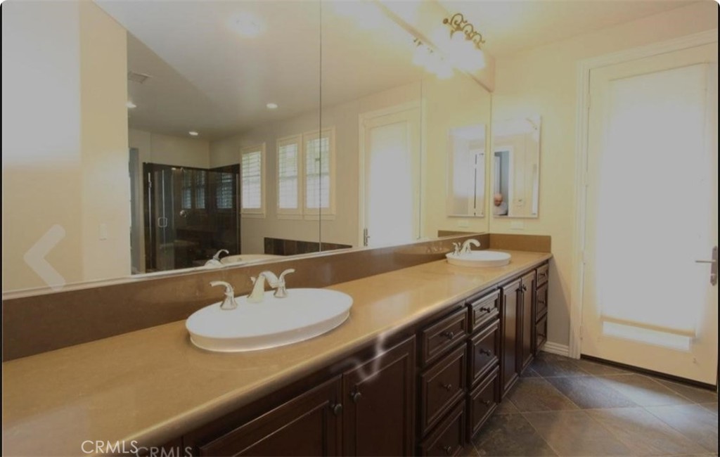 4591 Camino Del Sol Calabasas, CA 91302 - Photo 19 of 21 a bathroom with a sink double vanity granite and a mirror